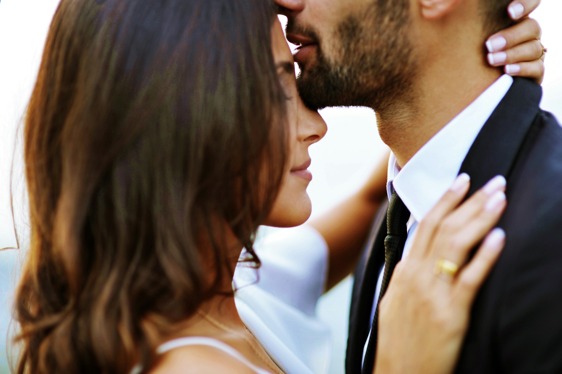 close shot of dark-haired bridal couple, bride on the left